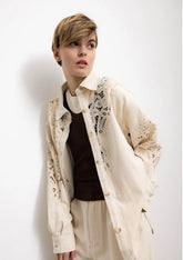 Woman wearing ecru lace detail shirt and wide leg pants set