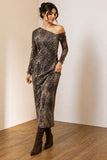 A woman models a long-sleeve off-the-shoulder midi dress with a brown and black leopard print, paired with dark brown suede boots, standing in a minimalist room with a beige wall and wooden floor.